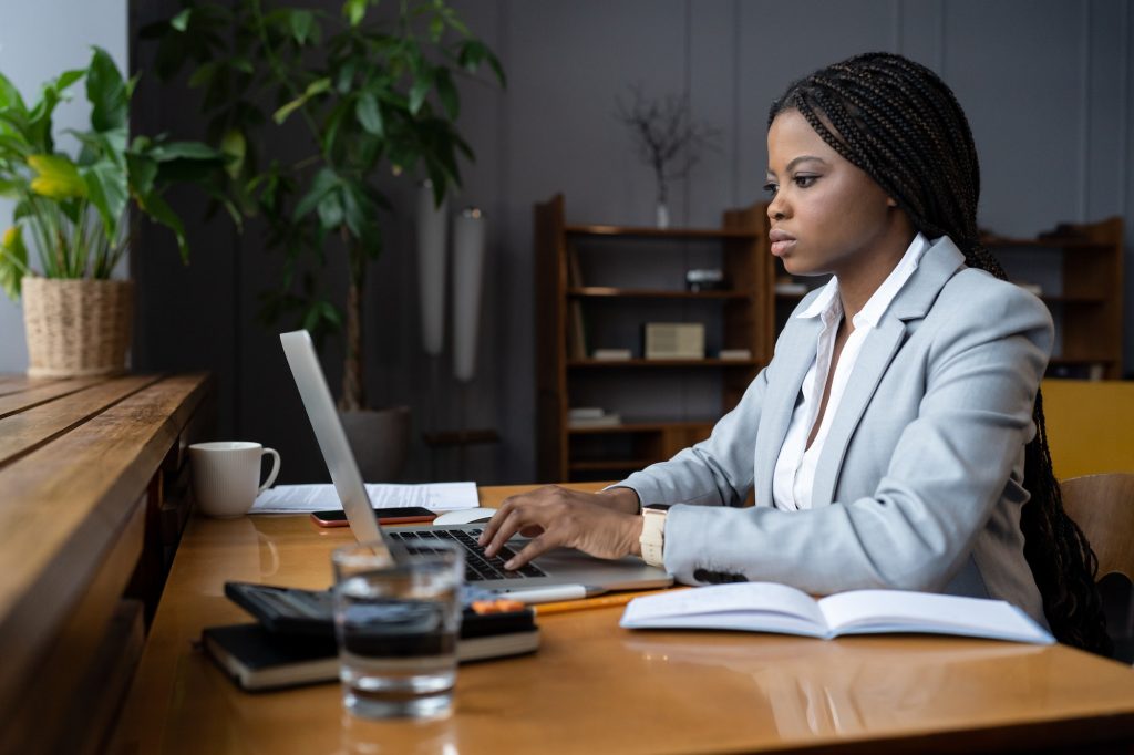 Serious frowning ceo businesswoman at desk look at laptop screen read email from partner concerned
